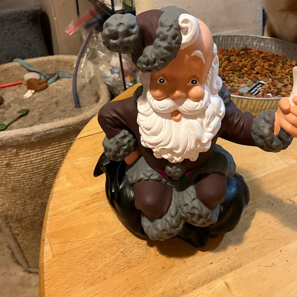 Hand painted Santa sitting on a bag